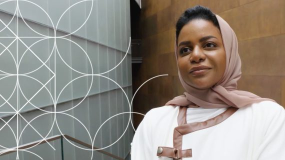 A woman in a white head covering. On her left, a white geometric pattern fades out.